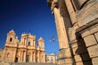 Basilica Minore di San Nicolo (Cathedral of St Nicholas), located on Piazza del Duomo (Duomo Square) in Noto, Syracuse, Sicily, Italy, with the town hall (Ducezio Palace) in the foreground on the righ