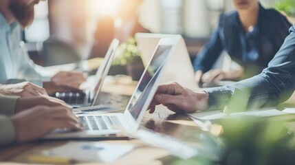 Concept of teamwork, work tasks and team union for the growth of the company. Group of employees working with their laptop and documents