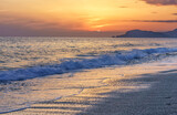 Fototapeta Boho - Colorful mediterranean sunset with surging waves on the beach in Alanya, Turkey.
