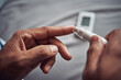 © peopleimages.com - Person, hand and blood sugar with finger for diabetes test or monitor insulin, glucometer or home. Medical, pen and checking as healthy measure or genetic problem with wellness, diagnostic or device