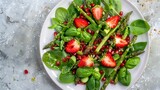 Fototapeta Londyn - Spring salad with strawberries pomegranate asparagus spinach basil leaves and citrushoney dressing Top view : Generative AI