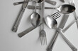 Table Knives, Tablespoons And Fork Chaotically Scattered On White Table Stock Photo
