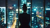 Fototapeta  - Successful Businesswoman in Stylish Suit Working on Top Floor Office Overlooking Night City. High Achievement Female CEO of Humanitarian Investment Fund, Human Face of Sustainable Corporate Governance
