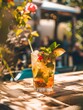 Glass of refreshing summer cocktail on wooden table in sunlight with blurred background. Vertical orientation