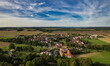 Aer ial view of a German village surrounded by meadows, farmland and forest. Thuringia, Germany.