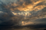 Fototapeta  - Dramatic storm sunset clouds skies heaven cloudscape background. Natural backgrounds: stormy sky.