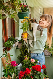Fototapeta Do akwarium - Woman Gardener with Cat in her Arms in Terrace Garden
