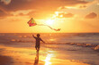 Young Boy Flying Kite on Beach at Sunset