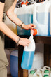 © GALDRIC - Female Customer Refilling Detergent at Zero Waste Grocery Store