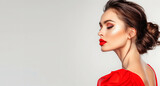 Fototapeta  - A woman in a red dress with red lipstick and earrings. She is standing in front of a white background. goddess with red lips in a red dress in profile, on a white background