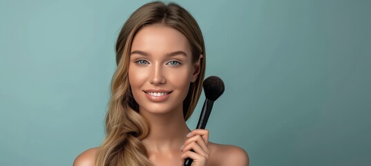 Wall Mural - Elegant woman with long blonde curly hair holding makeup brush on pastel background