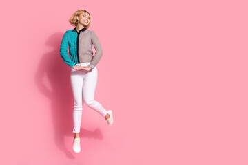 Wall Mural - Full size photo of pretty young girl jump elegant look empty space wear trendy striped cyan outfit isolated on pink color background