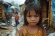A young girl stands in a slum with wet hair and a yellow dress, expressing a mix of innocence and resilience