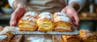 hands of cook serving a Sfogliatelle. Sfogliatelle is an Italian pastry originating from Naples, made of thin layers of crisp dough filled with a sweet ricotta cheese filling 
