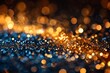 A close-up image capturing sparkling golden and blue lights creating a bokeh effect resembling glitter scattered across a surface