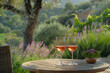 Two glasses of French rose wine on a table outdoors in a garden in Provence with fresh blooming lavenders in summer