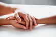 © peopleimages.com - Hands, support and hope for comfort or care on table, reassurance or empathy for bad news or illness. Closeup, friends and unity in crisis by prayer, trust or bond for person suffering with diagnosis
