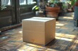A simple yet striking image of a lone cardboard box in a sunlit room, casting a soft shadow on the polished wooden floors