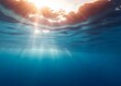 Underwater view with sun rays penetrating the ocean surface