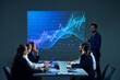 © master1305 - Colleagues in corporate environment gather in boardroom, studying digital stock chart displayed on monitor during meeting. Concept of business, entrepreneurship, trade market, economics, finances
