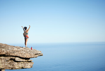 Wall Mural - woman, success and open arms on mountain cliff for freedom, achievement and explore in nature. hikin