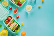 Top view of lunchbox with sandwiches, fruits and water in bottle