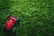 Top view of lawn mower on green grass