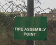 A sign marking where workers and visitors in a building should gather in the case of the building being evacuated because of fire and where the authorities can check if anyone is trapped inside