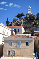 Wall Mural - Famous main picturesque village of Poros island featuring clock tower, Saronic Gulf, Greece