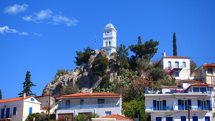 Wall Mural - Famous main picturesque village of Poros island featuring clock tower, Saronic Gulf, Greece