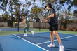 © Mat Hayward - Co-ed pickleball team. The players are active on the court for a fun and fast game.