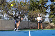 © Mat Hayward - Pickelball players in a competitive match on an outdoor court. The game is fun and exciting.