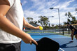 © Mat Hayward - Pickelball players in a competitive match on an outdoor court. The game is fun and exciting.