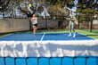 © Mat Hayward - Two female pickleball players work together as a team during a game on an outdoor court.