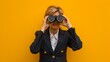 Woman with Binoculars Against Yellow