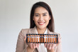Corporate office worker or business woman holding Japanese abacus, concept image of mental math, fast calculation training, Accounting with precise number calculation, professional financial worker