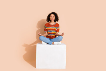 Sticker - Full body photo of calm focused girl dressed ornament t-shirt denim pants meditating on platform isolated on pastel color background