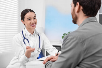 Poster - Doctor consulting patient during appointment in clinic