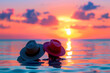 A couple in love with hats sitting on the beach watching the sunset and beautiful scenery taking place 