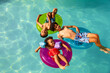 © McKinsey Jordan/Stocksy - Siblings Float On Inflatables In The Pool During Summer
