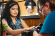 © Leonardo Borges Nuñez/Stocksy - Woman being attended by the manicurist.