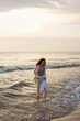 © Milles Studio/Stocksy - Beautiful sensual woman enjoying sea water at beach