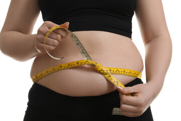 Sticker - Woman measuring belly with tape on white background, closeup. Overweight problem