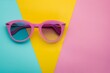 Sunglasses on color block background with shadows