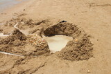 Fototapeta Tęcza - A sand castle with words written on it