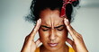 Young frustrated woman close-up face having a headache putting hands on side temples feeling mental pressure. Stressed out African American 20s person