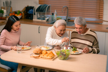 Family Togetherness in the Kitchen: Asian Mother Prepares a Happy Dinner, Joined by Father, Daughter, and Senior Elderly, Creating Fun and Memorable Meals, A Heartwarming Holiday Gathering