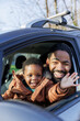 © Jovo Jovanovic/Stocksy - Happy kid waving while sitting with father in car