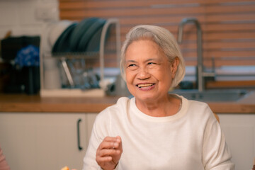 Family Togetherness in the Kitchen: Asian Mother Prepares a Happy Dinner, Joined by Father, Daughter, and Senior Elderly, Creating Fun and Memorable Meals, A Heartwarming Holiday Gathering