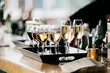 © CWP, LLC/Stocksy - Glasses of wine and sparking wine on a tray